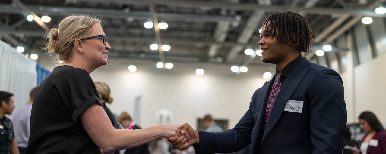 people shaking hands at career fair